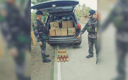 <p><strong>INTERCEPTED.</strong> The Anini-y Municipal Police Station in Antique intercepts in a checkpoint at Barangay San Francisco a sports utility vehicle loaded with 21 boxes of Tanduay on Wednesday (May 20, 2020). The police urged the public to adhere to the liquor ban, which remains in effect in Antique.<em> (Photo courtesy of APPO)</em></p>