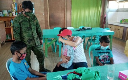 <p><strong>TEARFUL REUNION.</strong> After nine years, 38-year-old 'Apay', a member of the communist New People's Army, is reunited with her three sons at the headquarters of 23rd IB in Buenavista, Agusan del Norte on Saturday, May 23. Apay, who is pregnant, surrendered to the Army's 23rd Infantry Battalion on May 16 along with another pregnant colleague. <em>(PNA Photo by Alexander Lopez)</em></p>