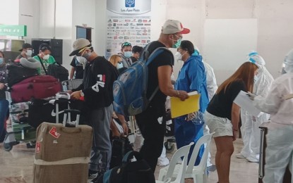 <p><strong>RETURNEES</strong>. Hundreds of overseas Filipino workers and locally stranded individuals from Negros Oriental arrive Tuesday morning (May 26, 2020) onboard two sweeper flights from Manila. Local government units were asked to fetch their locals at the Sibulan-Dumaguete airport in accordance with national guidelines on the Balik Probinsya program of the national government. <em>(Photo by Juancho Gallarde)</em></p>