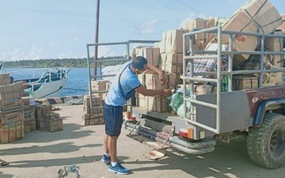 <p><strong>NO LIQUOR BAN.</strong> A law enforcer fixes the boxes of liquor seized in Caluya, Antique on May 20, 2020. Antique will no longer implement the liquor ban but Governor Rhodora Cadiao said its sale and consumption remain regulated. <em>(Photo courtesy of APPO/Caluya MPS)</em></p>