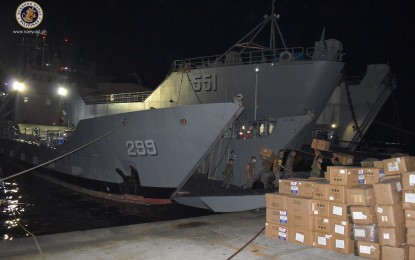 <p><strong>EN ROUTE TO VISAYAS.</strong> Navy personnel load boxes of medical supplies and personnel protective equipment (PPE) sets into the BRP Batak (LC-299) at the Sangley Point in Cavite on Wednesday (May 27, 2020). The ship was deployed to transport these equipment as well as military personnel to various provinces in the Visayas. <em>(Photo courtesy of the Naval Public Affairs Office)</em></p>
