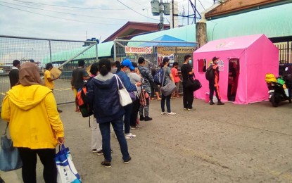 <p><strong>ON QUARANTINE.</strong> Passengers, mostly front-liners, undergo health protocol procedures before boarding the vessel plying the Zamboanga-Basilan route via Lamitan City. On Friday (May 29, 2020), trips to Basilan has been suspended as the vessel servicing the Zamboanga-Basilan route has been placed on quarantine. <em>(Photo courtesy of Jerry Amaga)</em></p>