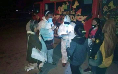 <p><strong>CAREFUL INSPECTION.</strong> Health front-liners check the documents of returning overseas Filipinos (ROFs) upon their arrival at the General Santos City International Airport on Thursday night (May 28, 2020). Upon their return to Maguindanao later on the same day, the ROFs, numbering 15, were immediately placed in isolation for the required 14-day quarantine for returning residents. <em>(Photo courtesy of Maguindanao PDRRMO)</em></p>