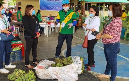 <p dir="ltr"><strong>AGRI-STORE.</strong> Davao Region Agricultural Cooperative Chairman Bong Cajes (center) shares on May 15, 2020 to officials of the Department of Agriculture in Davao Region how they consolidate farmers' produce to be sold in 'Kadiwa on Wheels'. The initiative has already generated a total of PHP15.3 million after 49 days of operation in at least 32 barangays in Davao City. <em>(Photo courtesy of Agri Info Davao)</em></p>
