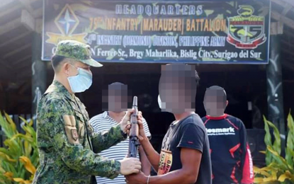 <p><strong>NEW LIFE.</strong> Lt. Col. Warren Munda (left), commander of the Army's 75th Infantry Battalion, welcomes the three communist New People’s Army members who surrendered on May 31, 2020 at the 75IB headquarters in Barangay Maharlika, Bislig City, Surigao del Sur. The surrenderers say they regret joining the communist rebel movement and now simply want a peaceful life with their families. <em>(Photo courtesy of 75thIB)</em></p>