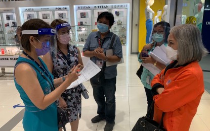 <p><strong>MALL INSPECTION.</strong> Trade department regional director Rebecca Rascon (right) talks to the representatives of the SM City mall management during an inspection to check on their compliance with health protocol in workplaces on Wednesday (June 3, 2020). Rascon said the inspection is continuous until a degree of compliance is met. <em>(Photo courtesy of David Israel F. Sinay/DTI VI)</em></p>