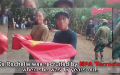 <p><strong>EX-REBEL.</strong> “Ka Rachelle” (left) holds a Communist Party of the Philippines flag with a comrade when she was still a New People’s Army combatant. In a video released by the Philippine Army’s 303rd Infantry Brigade on Tuesday (June 2, 2020), she admitted that she was sexually abused by an NPA commander. <em>(Screenshot from 303rd Infantry Brigade, Philippine Army video)</em></p>