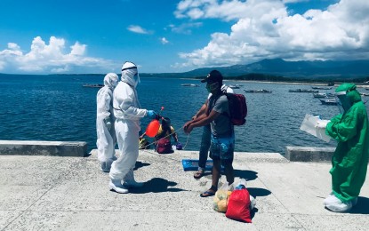 <p><strong>RETURNEES</strong>. Twelve locally-stranded individuals from Aklan arrive in Tanjay City, Negros Oriental on Wednesday (June 3, 2020) aboard the fishing boat FCBA Teresita. Nine of them are from Tanjay City, two from Amlan, and one from Pamplona. <em>(Photo courtesy of Tanjay City DRRMO)</em></p>