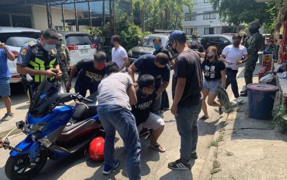 <p><strong>ARRESTED.</strong> Police personnel arrest Cpl. Esteven Mark Pandi in an operation in Pasig City on Wednesday (June 3, 2020). Pandi was arrested for using a motorcycle that was seized from an anti-drug operation in the city last year.<em> (Photo courtesy of IMEG)</em></p>