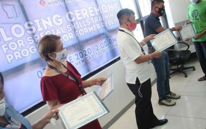 <p><strong>NEW LIFE.</strong> Government officials award certificates to former rebels in Northern Samar who completed the skills training program of the Technical Education and Skills Development Authority (TESDA) on Thursday (June 4, 2020). At least 18 former rebels have undergone the three-month training on bread and pastry production and cookery at Las Navas Agro-Industrial School in Las Navas town. <em>(Photo courtesy of Northern Samar provincial information office)</em></p>
