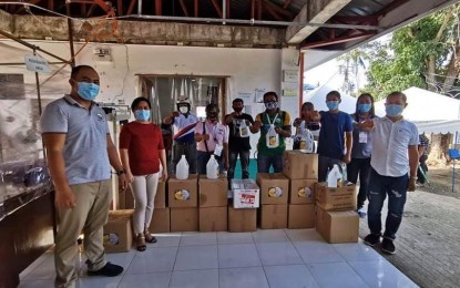 <p><strong>LSI's DEATH.</strong> Caluya Mayor Regil Kent Lim (left) and Municipal Health Office chief, Dr. Anna Marie Villalobos (second from left), distribute medical supplies and protective personal equipment to village chiefs in an undated photo. Villalobos said on Tuesday (June 9, 2020) that the death of a locally stranded individual in Barangay Semirara is not due to Covid-19 but a heart attack.<em> (Photo courtesy of Semirara LGU)</em></p>