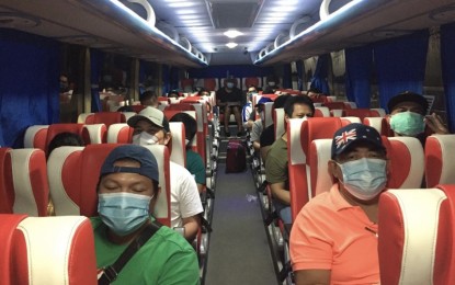 <p><strong>REPATRIATED OFWS</strong>. Some of the 51 overseas Filipino workers ride a bus from their temporary shelter in Cebu to the port area to board a boat going to Tagbilaran City, Bohol. Overseas Workers Welfare Administration (OWWA)-Central Visayas Regional Director Mae Codilla on Tuesday (June 9, 2020) said her office has facilitated the travel of about 2,870 OFWs back to their respective provinces in Regions 7 and 8. <em>(Photo courtesy of OWWA-7)</em></p>