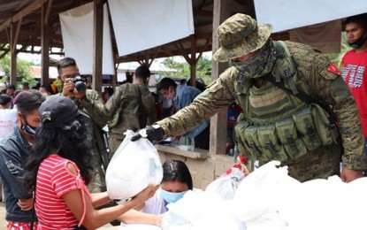 <p><strong>OUTREACH PROGRAM.</strong> A soldier of the Army’s 53rd Infantry Battalion (53IB) hands over a food pack to a housewife during an outreach mission in Barangay Duelic, Midsalip, Zamboanga del Sur. Some 250 poor families benefited from the outreach mission jointly held Sunday by the 53IB and the office of Congresswoman Divina Grace Yu of the first district of Zamboanga del Sur. <em>(Photo courtesy of 53IB)</em></p>