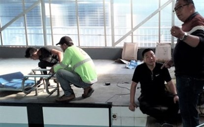 <p><strong>OLYMPIC STANDARD DREAMS.</strong> RAJ Constructions and its Korean subcontractor install the electronic timer of the Baguio swimming pool last March 11 before the city was declared under enhanced community quarantine that stopped constructions. Here RAJ Constructions Rowland A. Julian (right) talks with his Korean sub-contractor on the installation of the electronic timer, diving board, and touchpad, while his workers assemble one of the boards. <em>(PNA file photo)</em></p>