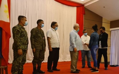 <p><strong>AID FOR EX-REBELS.</strong> Zamboanga del Norte Gov. Roberto Uy (4th from left), chairperson of the Provincial Task Force to End Local Communist Armed Conflict, leads the distribution of financial aid to 20 former communist New People's Army rebels in Dipolog City. Each former rebel receives PHP65,000 financial assistance for a total of PHP1.3 million. <em>(Photo courtesy of the Army's 1st Infantry Division)</em></p>