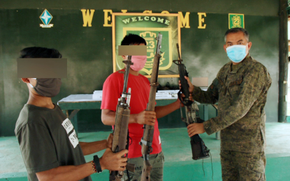 <p><strong>RECOVERED FIREARMS</strong>. Lt. Col. Julius Cesar C. Paulo (right), commander of the Army's 23rd Infantry Battalion, receives from "Michael" and "Niko", former New People's Army combatants, the four high-powered firearms recovered in the hinterlands of Sitio Likudon, Barangay Kamanikan, Gingoog City, during a turnover ceremony on Friday (June 12, 2020) at the 23IB headquarters in Buenavista, Agusan del Norte. <em>(PNA photo by Alexander Lopez)</em></p>