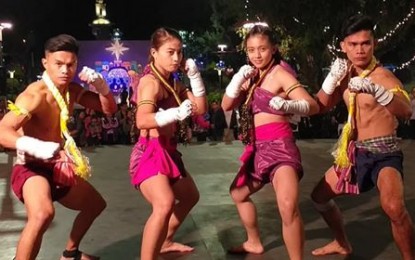 <p><strong>ATHLETE ALLOWANCE</strong>. At least for another month, national athletes would enjoy a full allowance from the Philippine Sports Commission as their stipend was supposed to be cut in half this month. The Muay Thai wiakru taksa team pose after a performance at the Baguio Christmas Village late November 2019 before they competed in the Southeast Asian Games. From left are Jearome Calica, Iredin Lapitan, Ruscha Bayacsan, and Joemar Gallanza. <em>(PNA photo by Pigeon Lobien)</em></p>