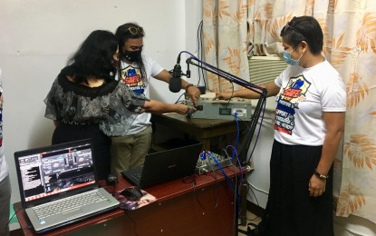 <p><strong>RADIO AS MODE OF LEARNING.</strong> Department of Education Laoag City Schools Division Superintendent Vilma Eda, City Councilor Roque Benjamin Ablan, and education consultant Isabel Sandi (from right to left), turn on the switch of the first school-based FM broadcast station as a tool for radio-based instruction in the region, on Monday (June 15, 2020). With the help of various stakeholders, the FM station will be upgraded to address the needs of learners in the province who have no access to online learning.<em> (Photo by Leilanie G. Adriano)</em></p>