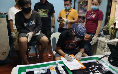 <p><strong>BUSTED.</strong> Police and Philippine Drug Enforcement Agency operatives arrest a businessman and a teenage high-value-target drug personality in separate anti-drug operations in the region. Photo shows PDEA operatives conducting an inventory on the illegal drugs allegedly seized from the teenage HVT (seated, left) during his arresting in Labangan, Zamboanga del Sur. <em>(Photo courtesy of PDEA-9)</em></p>