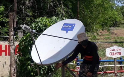 <p><strong>SATELLITE COMMUNICATION SYSTEM</strong>. A technician installs a very small aperture terminal (VSAT) dish at the Bacsil Elementary School in Laoag City on June 19, 2020. DepEd Laoag City hopes to have more of this kind in support of the “new normal” education of children with poor internet connectivity. <em>(Photo courtesy of DepEd Laoag City Inforboard)</em></p>
<p> </p>