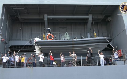 <p><strong>ON THE WAY HOME.</strong> Passengers wave aboard the BRP Davao del Sur, as it leaves the Manila South Harbor on their way to their hometowns in the Visayas on Monday (June 22, 2020). The passengers will disembark at the Port of Iloilo and only medical supplies will be transported to Cebu City which has been reverted to the enhanced community quarantine. <em>(Photo courtesy of the Naval Public Affairs Office)</em></p>