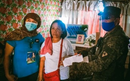 <p><strong>FINANCIAL ASSISTANCE</strong>. The local government unit of Mabinay, Negros Oriental, and the 11th Infantry Battalion of the Philippine Army on Sunday (June 21, 2020) handed over financial assistance to the family of a suspected NPA member who was killed in an encounter with government troops in that town last June 18, 2020. Shown in photo are (from left to right) Elna Bito, Livelihood Branch staff of the Municipal Social Welfare and Development Office, Emma Ravilista, wife of the deceased Isaias Ravilista alias "Ka Jabar"; and Sgt. Ramie L. Cabayao of the 11th Infantry Battalion, Philippine Army. <em>(Photo courtesy of the 11th IB/3ID/Philippine Army)</em></p>