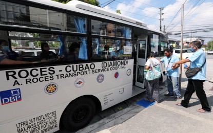 <p>A passenger boarding a modern jeepney in Metro Manila. <em>(PNA Photo)</em></p>