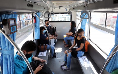<p><strong>DISTANCIA, AMIGO.</strong> Passengers maintain distance between each other inside a public utility vehicle in this file photo. Department of Transportation (DOTr) Secretary Arthur Tugade ordered all transportation sectors to implement the “one-seat apart” rule to increase public transport capacity.<em> (PNA photo by Joey Razon)</em></p>