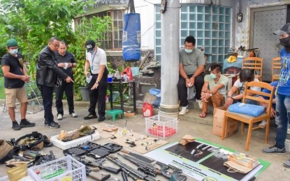 <p><strong>ANTI-DRUG OPS.</strong> PDEA Director General Wilkins Villanueva (2nd from left), inspects drug paraphernalia, firearms, and explosives seized in an operation in Barangay San Bartolome, Novaliches, Quezon City on Sunday (June 21, 2020). The raid is one of the three separate anti-drug operations launched by PDEA operatives which yielded over PHP42 million worth of shabu. <em>(Photo courtesy of PDEA)</em></p>