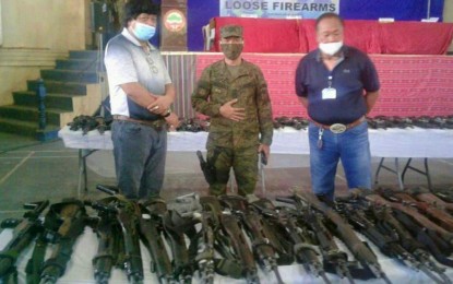 <p><strong>LOOSE FIREARMS.</strong> Mayor Abubakar Paglas (right) of Datu Paglas, Maguindanao looks at the 120 loose firearms surrendered by various barangays in the municipality and handed over to the Army’s 6th Infantry Division on Monday (June 22) during ceremonies held at the town hall. The firearms were documented as government property and issued back to government militia forces for the maintenance of peace and security in the area. (<em>Photo courtesy of DXMY-Cotabato</em>) </p>