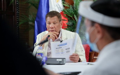 <p>President Rodrigo R. Duterte holds a document during a meeting with members of the Inter-Agency Task Force for the Management of Emerging Infectious Diseases at the Malago Clubhouse in Malacañang on June 22, 2020. (<em>ROBINSON NIÑAL JR./PRESIDENTIAL PHOTO</em>)</p>
