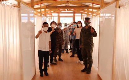 <p><strong>PATIENT CARE CENTERS.</strong> Officials from the AFP, Muntinlupa City government, and private sector partners take a tour of one of two emergency quarantine facilities (EQFs) in Barangay Sucat in Muntinlupa City on Tuesday (June 23, 2020). The two EQFs have a total bed capacity of 40. <em>(Photo courtesy of the Office of the Chief Engineer, AFP)</em></p>