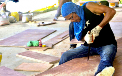 <p><strong>'KATRE-KARPINTERO'</strong>. A carpenter in Dinagat Islands builds a bed for the Covid-19 patient care centers in the province. Dubbed 'Katre-Kapintero', the initiative aims to equip the province's care and containment centers located in seven municipalities, while providing employment to 21 carpenters. <em>(Contributed photo)</em></p>