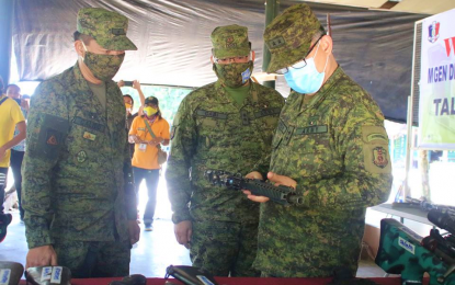 <p><strong>WAR MATERIALS NO MORE.</strong> Major Gen. Diosdado Carreon (right), Army’s 6th Infantry Division commander and Joint Task Force Central (JTFC) chief, inspects one of two rifles surrendered by two combatants of the Islamic State-linked Bangsamoro Islamic Freedom Fighters in Gen. S. K. Pendatun on Wednesday (June 24, 2020). Looking on are Lt. Col. Rogelio Gabi (center), 40th Infantry Battalion commander, and Brig. Gen. Roy Galido, 601st Infantry Brigade chief. <em>(Photo courtesy of 40IB)</em></p>