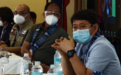 <p><strong>COVID-19 RESPONSE.</strong> Interior Secretary Eduardo Año (right) and Presidential Adviser on the Peace Process and chief implementer of National Task Force Against Covid-19 Carlito Galvez Jr. (center) listen to the presentation of local officials in Eastern Visayas on coronavirus disease 2019 (Covid-19) cases management. Año approved the proposal to temporarily suspend the return of stranded residents to Eastern Visayas as Covid-19 cases continue to rise in the past three weeks. (PNA photo by Roel Amazona)</p>