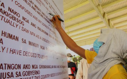 <p><strong>WITHDRAWAL OF SUPPORT.</strong> Forty-eight former communist New People’s Army rebels signify their withdrawal of support to the communist movement by pledging loyalty to the government in a ceremony held at the headquarters of Police Regional Office Caraga on Friday (June 26, 2020). The former rebels also burned the NPA flag. <em>(PNA photo by Alexander Lopez)</em></p>