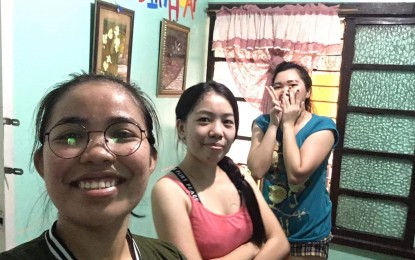 <p><strong>GRIT AND PASSION.</strong> Aileen Bucio (leftmost) with her dormmates, Virgi and Lovely. Bucio, an early childhood education graduate, offers online tutorial classes to get through the pandemic. <em>(Photo by Aileen Burcio)</em></p>