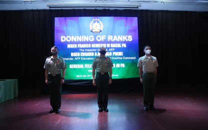 <p><strong>PROMOTED.</strong> AFP Chief of Staff, Gen. Felimon Santos Jr. (center), presides over the donning of ranks ceremony for two military officials in Camp Aguinaldo on Tuesday (June 30, 2020). Promoted to the next higher rank were AFP Inspector General, Lt. Gen. Franco Nemecio Gacal (left), formerly major general, and concurrent head of the AFP Education Training and Doctrine Command and spokesperson, Marine Maj. Gen. Edgard Arevalo (right), formerly brigadier general. <em>(Photo courtesy of AFP Public Affairs Office)</em></p>