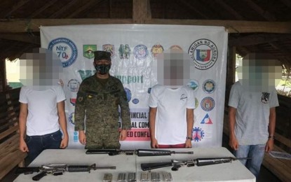 <p><strong>BACK TO THE FOLD OF THE LAW.</strong> Three ranking leaders of the New People's Army surrender their firearms to the Army’s 91st Infantry Battalion (91IB) and Philippine National Police (PNP) in a secluded area of Sitio Balitwak, Barangay San Isidro, San Luis, Aurora on Saturday, June 27, 2020. Also in photo is Lt. Col. Reandrew Rubio, commander of 91st Infantry (Sinagtala) Battalion. <em>(Photo courtesy of the Army's 9th Infantry Battalion)</em></p>