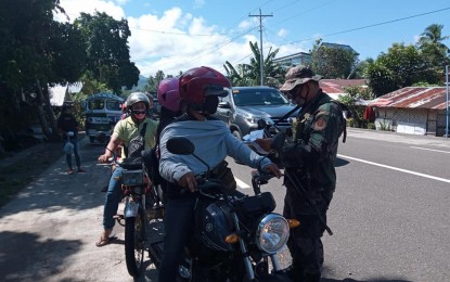 <p><strong>COVID-19 WATCH</strong>. A police officer checks motorists entering Libagon, Southern Leyte in this undated photo. The local government of Libagon lifted the enhanced community quarantine in Nahulid village on Wednesday (July 1, 2020) days after it was imposed on June 19, to trace those who had contact with the two residents who tested positive for coronavirus disease. <em>(File photo courtesy of Libagon police station)</em></p>