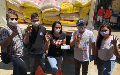 <p><strong>CLUSTER WAR WINNERS.</strong> Quarantine-themed music video contest winner Arvyn Grace Into (center), who is from Cluster 3, receives the cash prize of PHP350,000 and sacks of rice from the staff of Davao City 1st District Rep. Paolo 'Pulong' Duterte on May 5, 2020. Photo also shows Councilor Danilo Dayanghirang (2nd from right). <em>(Contributed photo)</em></p>