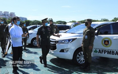 <p><strong>NEW VEHICLES.</strong> Army commander, Lt. Gen. Gilbert Gapay (center), takes a look at one of the new vehicles donated to the Philippine Army by the Armed Forces and Police Mutual Benefit Association Inc. in Fort Bonifacio, Taguig City on Friday (July 10, 2020). The new vehicles are expected to boost the Army's capability in curbing terror threats and battling the Covid-19 pandemic. <em>(Photo courtesy of the Army Chief Public Affairs Office)</em></p>