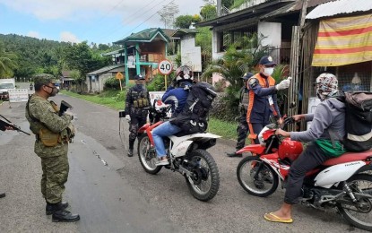 <p><strong>HEIGHTENED WATCH</strong>. Motorists entering Mahaplag town in Leyte undergo thermal scanning in this July 7, 2020 photo. Two villages in Mahaplag were placed under a 48-hour heightened surveillance and security measures starting Thursday night (July 9, 2020) after a resident tested positive for coronavirus disease 2019. <em>(Photo courtesy of Mahaplag police station)</em></p>