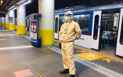 <p><strong>MRT-3 REOPENS.</strong> A security guard of the Metro Rail Transit Line 3 (MRT-3) wears full personal protective equipment inside one of its stations on Monday (July 13). Following its reopening, the MRT-3 said it now prohibits talking inside its trains as an added safeguard against the coronavirus disease (Covid-19). <em>(Photo courtesy of MRT-3)</em></p>