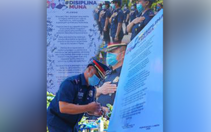 <p><strong>ADVOCACY DRIVE.</strong> Brig. Gen. Jesus Cambay Jr., Police regional Office-9 (PRO-9) director, affixes his signature as he leads Monday (July 13, 2020) the launch of the 'Disiplina Muna' advocacy campaign in the region. The program aims to promote the culture of discipline among Filipinos.<em> (Photo courtesy of PRO-9 Public Information Office)</em></p>