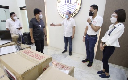 <p><strong>HELP FROM THE HOUSE</strong>. Mayor Edgardo Labella (2nd from left) receives personal protective equipment, non-contact infrared thermometers, Lenovo laptops, vitamins, and P1-million check donated by the House of Representatives on Monday (July 13, 2020) at the City Hall. On behalf of House Speaker Alan Peter Cayetano, Cebu's 7th District Rep. Pablo John Garcia (center) 5th District Rep. Vincent Franco “Duke” Frasco (2nd from right) and Liloan Mayor Christina Garcia Frasco (right) turned over the items to fight the Covid-19. <em>(Photo courtesy of Cebu City Hall PIO)</em></p>