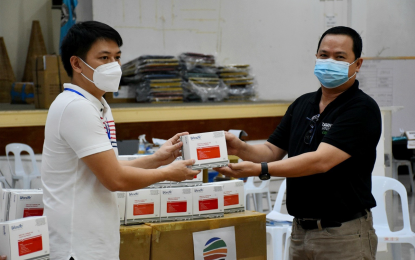 <p><strong>RESPONSIBLE MINING.</strong> Surigao del Norte Vice Governor Eddie Gokiangkee Jr. receives the 5,000 rapid test kits donated by Taganito Mining Corporation, represented by its resident mine manager Artemio Valeroso, sometime in June 2020. As of early July, the company has so far spent some PHP19.1 million for various coronavirus disease response in the province. <em>(Contributed Photo)</em></p>