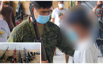 <p><strong>SURRENDER.</strong> Lt. Col. Rommel Valencia (left), the Army’s 7th Infantry Battalion commander, accepts the rifle of one of five surrendering members of the communist New People’s Army during simple rites held at the old capitol building in Isulan, Sultan Kudarat on Tuesday (July 14, 2020). The rebel returnees also yielded high-power firearms and ammunition.<em> (Photo courtesy of 7IB)</em></p>