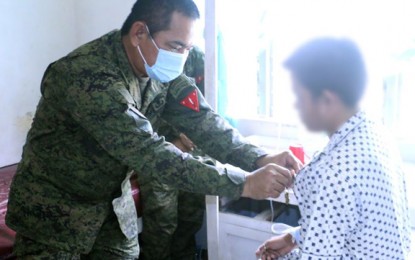 <p><strong>HERO TROOPER.</strong> Maj. Gen. Generoso Ponio, commander of the 1st Infantry Division, pins a Wounded Personnel Medal Friday (July 24, 2020) to a military who was wounded in a clash on July 21, 2010 against 20 communist terrorists New People's Army in Barangay Sto. Niño, Gutalac, Zamboanga del Norte. The militiaman is undergoing medical treatment at Camp Sang-an Station Hospital. <em>(Photo courtesy of the 1st Infantry Division Public Affairs Office)</em></p>