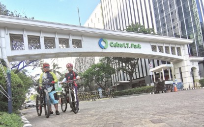 <p><strong>IMPROVED CONNECTIVITY.</strong> Cebu journalist Roger Vallena and a fellow biker stop by at the entrance archway of the Cebu IT Park, home of Central Visayas region's business process outsourcing. IT BPM Organization managing director Wilfredo Sa-a Jr. said reliability in faster internet connectivity is even more vital now as more people work from home and rely on for submission of deliverables. <em>(Photo courtesy of Roger Vallena)</em></p>
<p> </p>